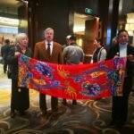 On January 28, 2019, the current US Ambassador to China, Terry Branstad (pictured), praised the "Double Dragon Play Bead" long scarf produced by Aurora Group's brand "Silkworm Seal" with Chinese style.