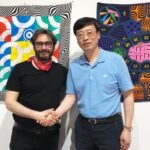 Aurora Chairman Deng Tao (right) and Herm è s designer (left) take a photo together